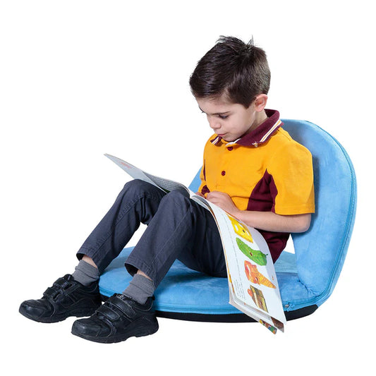 school boy sitting and reading in the blue anywhere chair