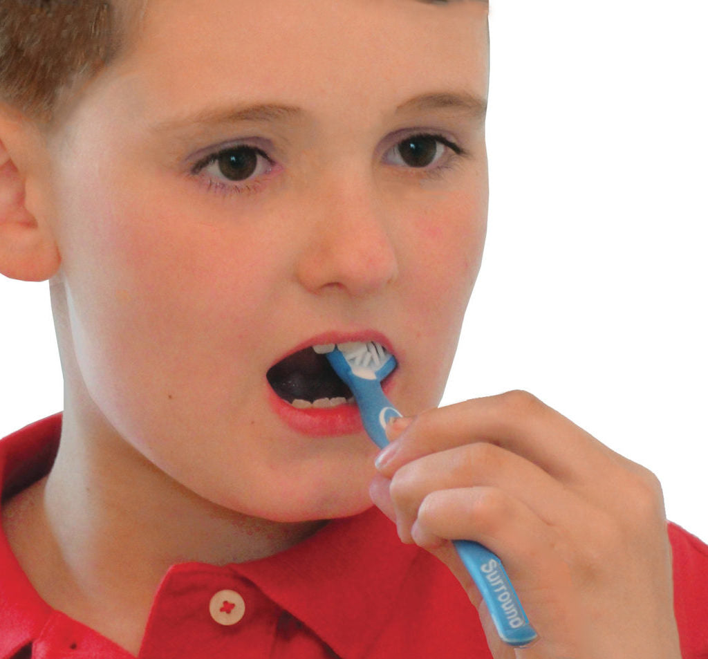 boy brushing teeth with surround three headed toothbrush
