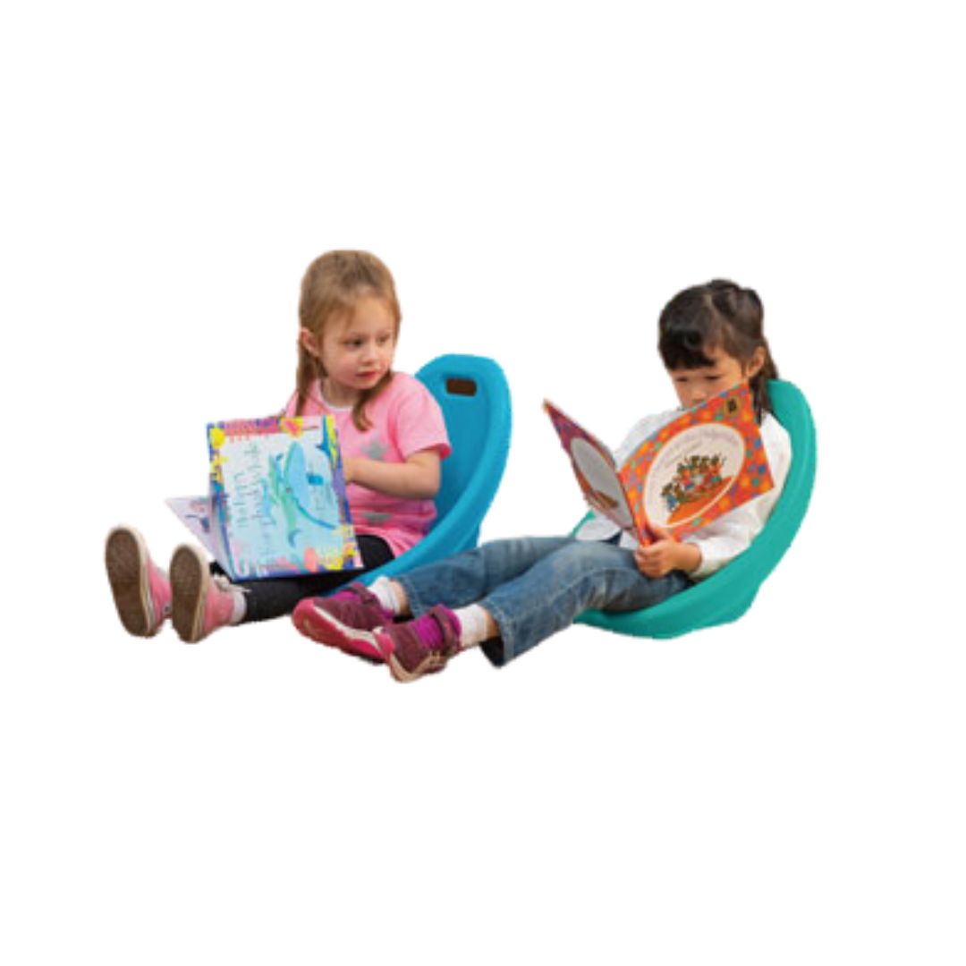 reading a book in the small floor rocking chair