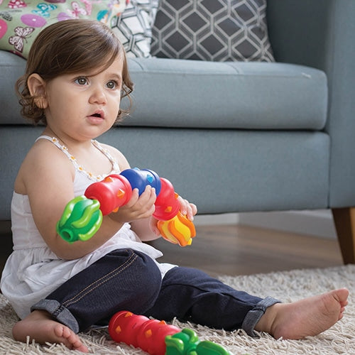toddler playing with Sensory Snap Beads