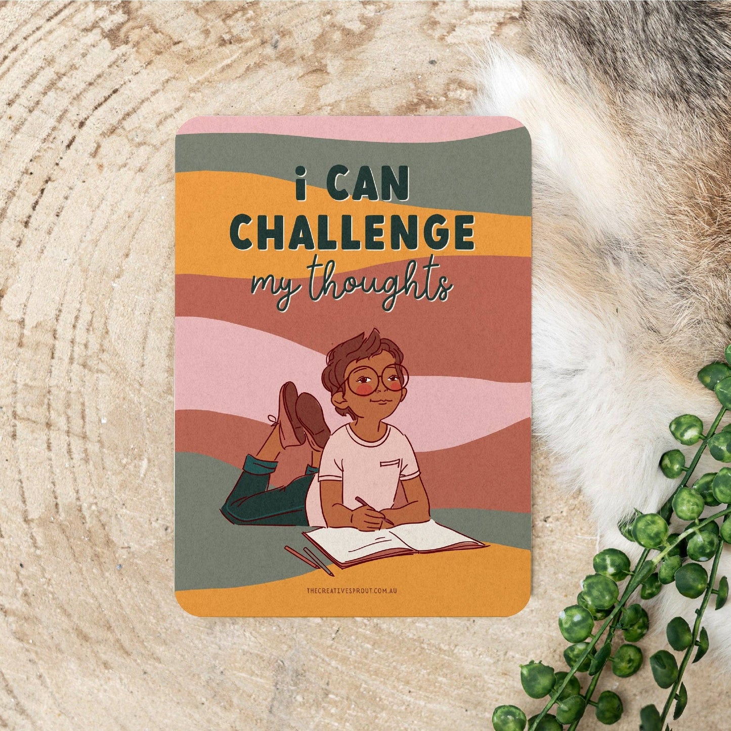 Flash card with illustration of a person reading a book and text 'I can challenge my thoughts'