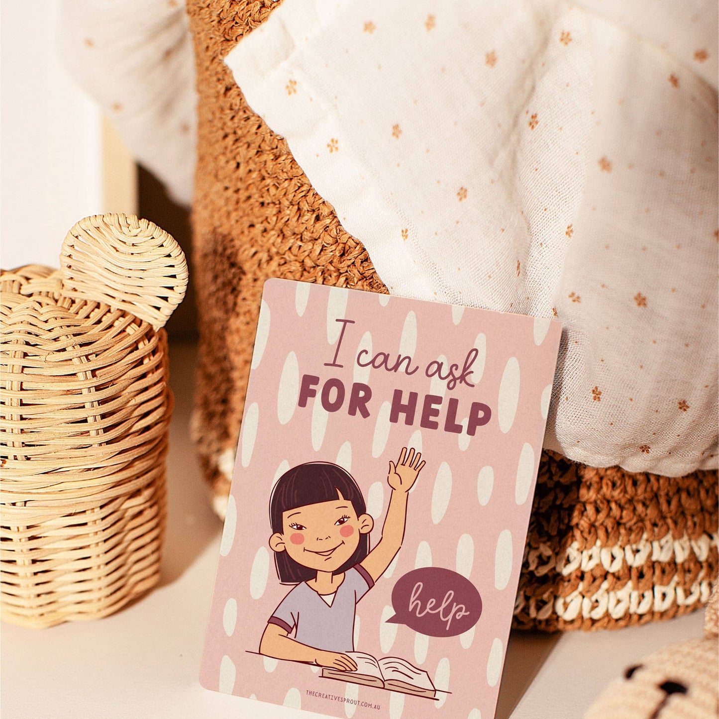 flash card 'I can ask FOR HELP' with a child illustration on a soft textured background