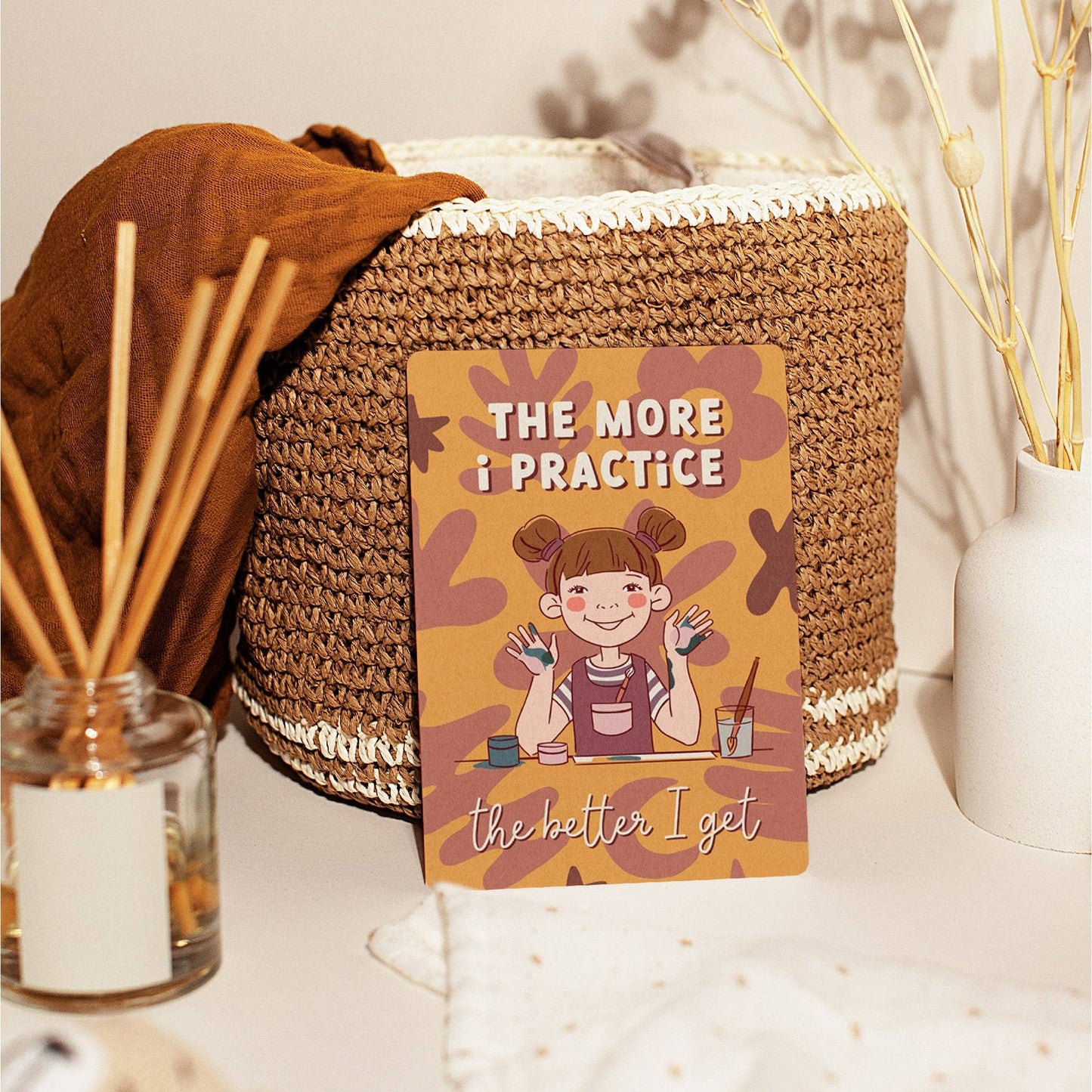 Decorative basket with an affirmation card featuring an illustrated child the more i practice the better I get