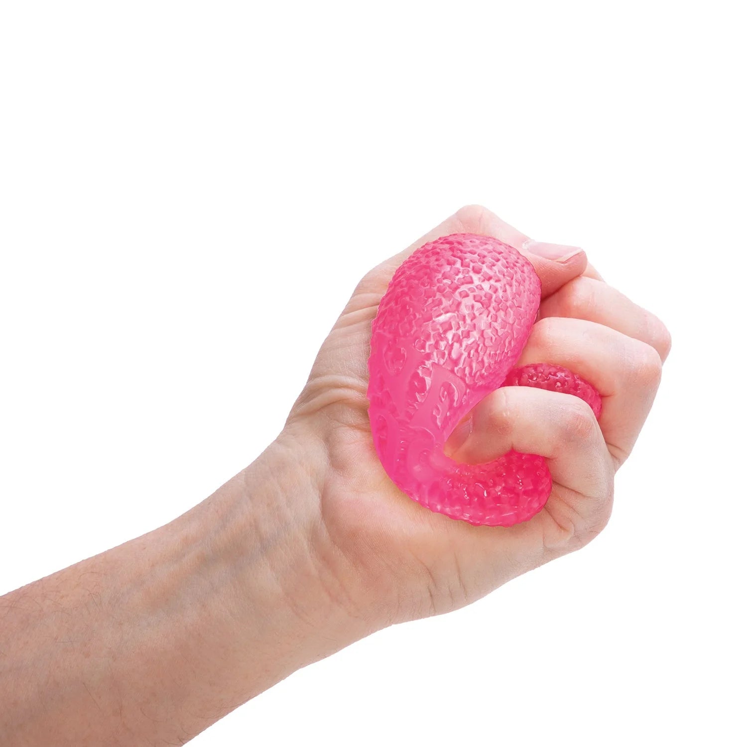 Hand squishing a pink textured stress ball against a white background