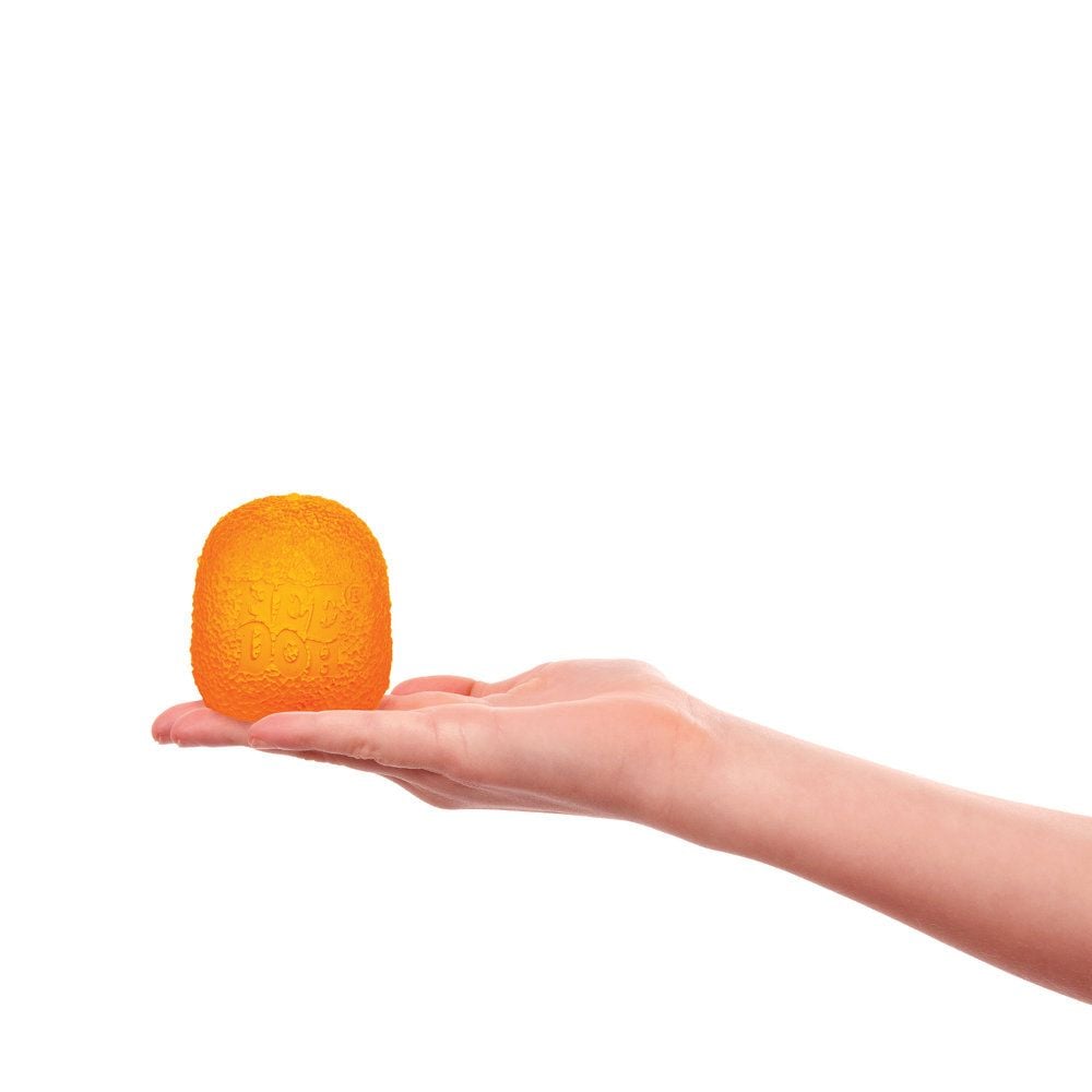 Hand holding a textured orange gumdrop needoh