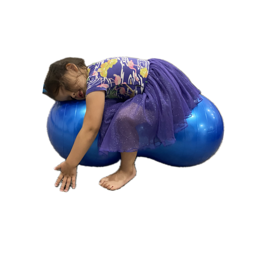 Girl laying on sensory peanut ball