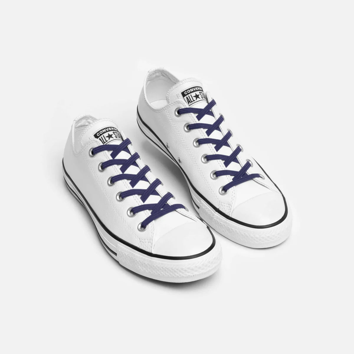Navy blue no tie flat laces in a pair of cons