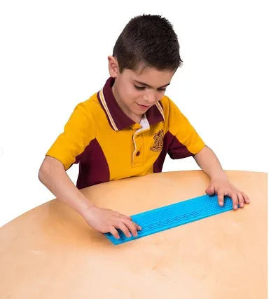 Boy using busy fingers tactile ruler