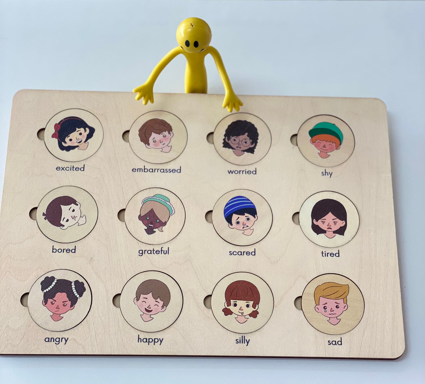 Bendy man holding wooden feelings puzzle