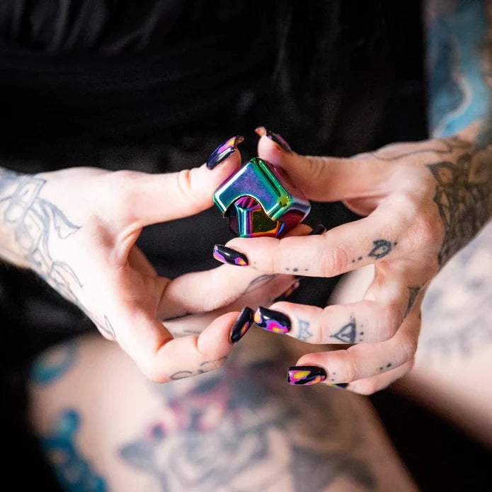 hands holding the oil slick spinning fidget cube