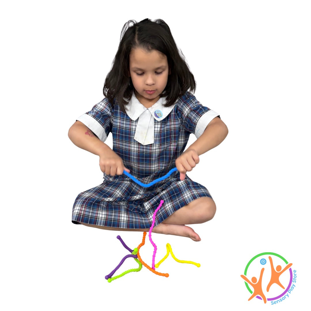 Child playing with colourful textured bendy sticks