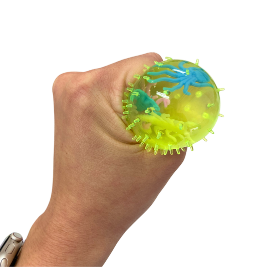 Hand squishing a squishy splat stress ball on a white background