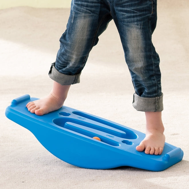 cropped child standing on a blue balance board seesaw weplay
