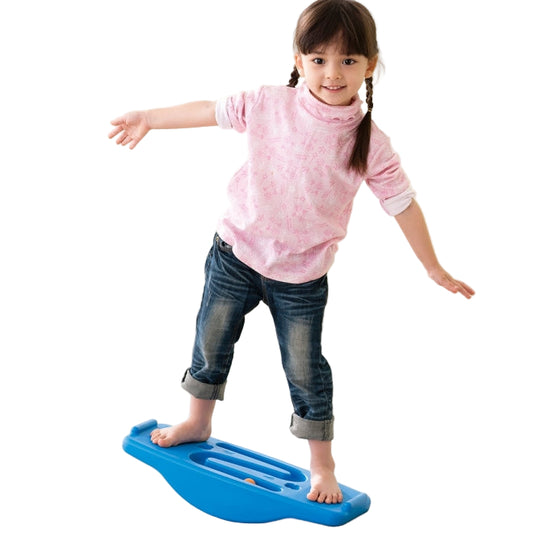 Child standing on a blue weplay seesaw balance board with a ball run