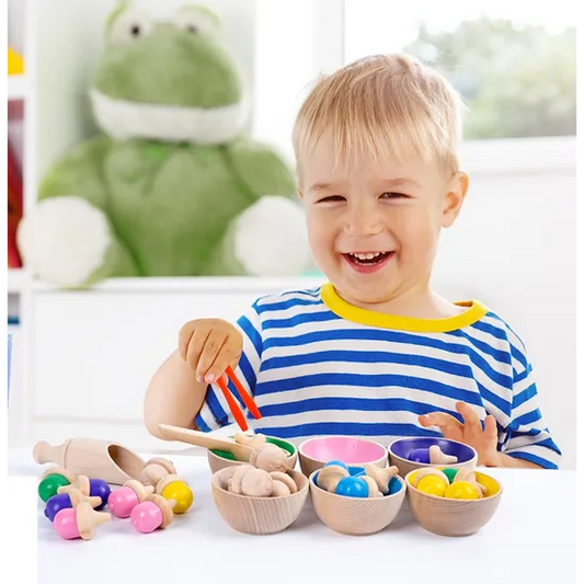 boy sorting Montessori coloured acorns into bowls