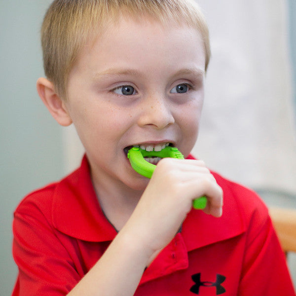 Boy chewing on a Textured Grabber lime