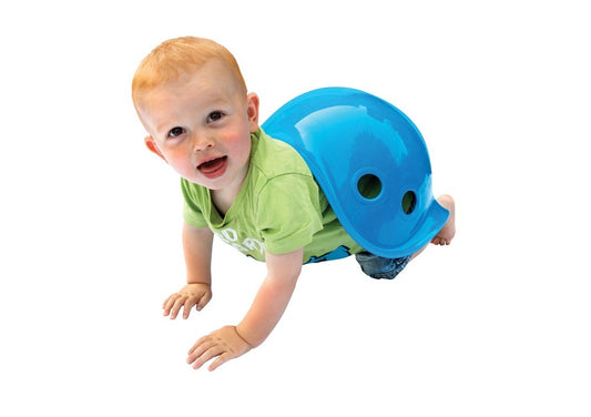 toddler playing with blue shell shaped balance toy