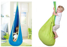 Kids climbing and reading in the pod swing