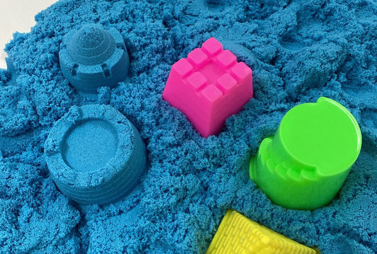 Blue Magic Sand in sensory tray with moulds