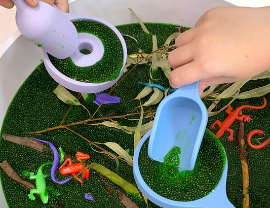 Kids playing with tools in a sensory play tray