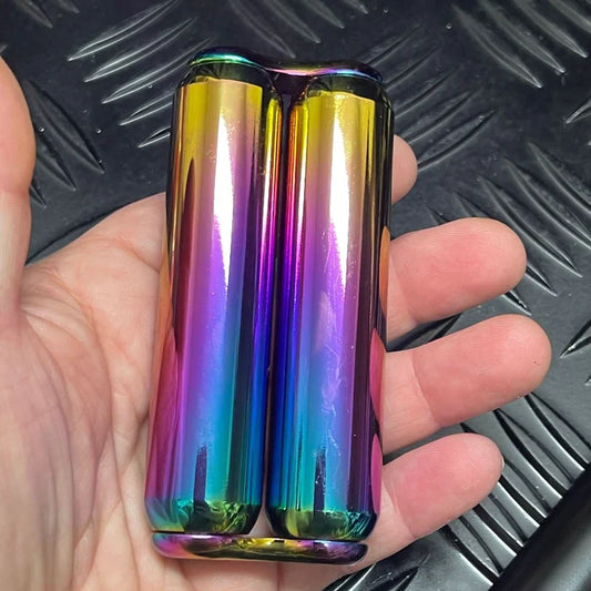 Hand holding the 470gram smooth hand roller which looks like two iridescent cylindrical objects.