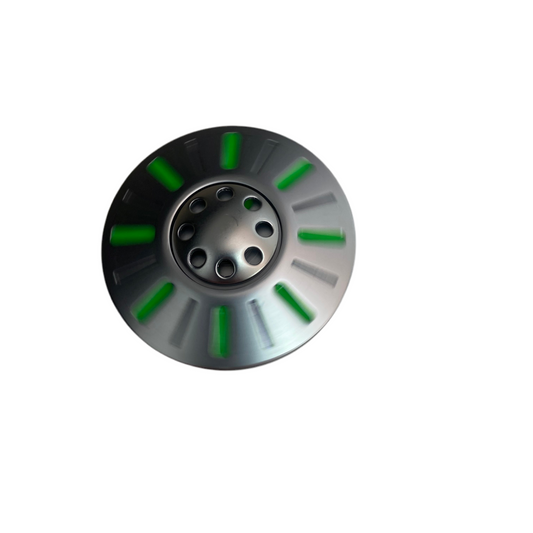 Metallic disc spinning  with green accents on a white background