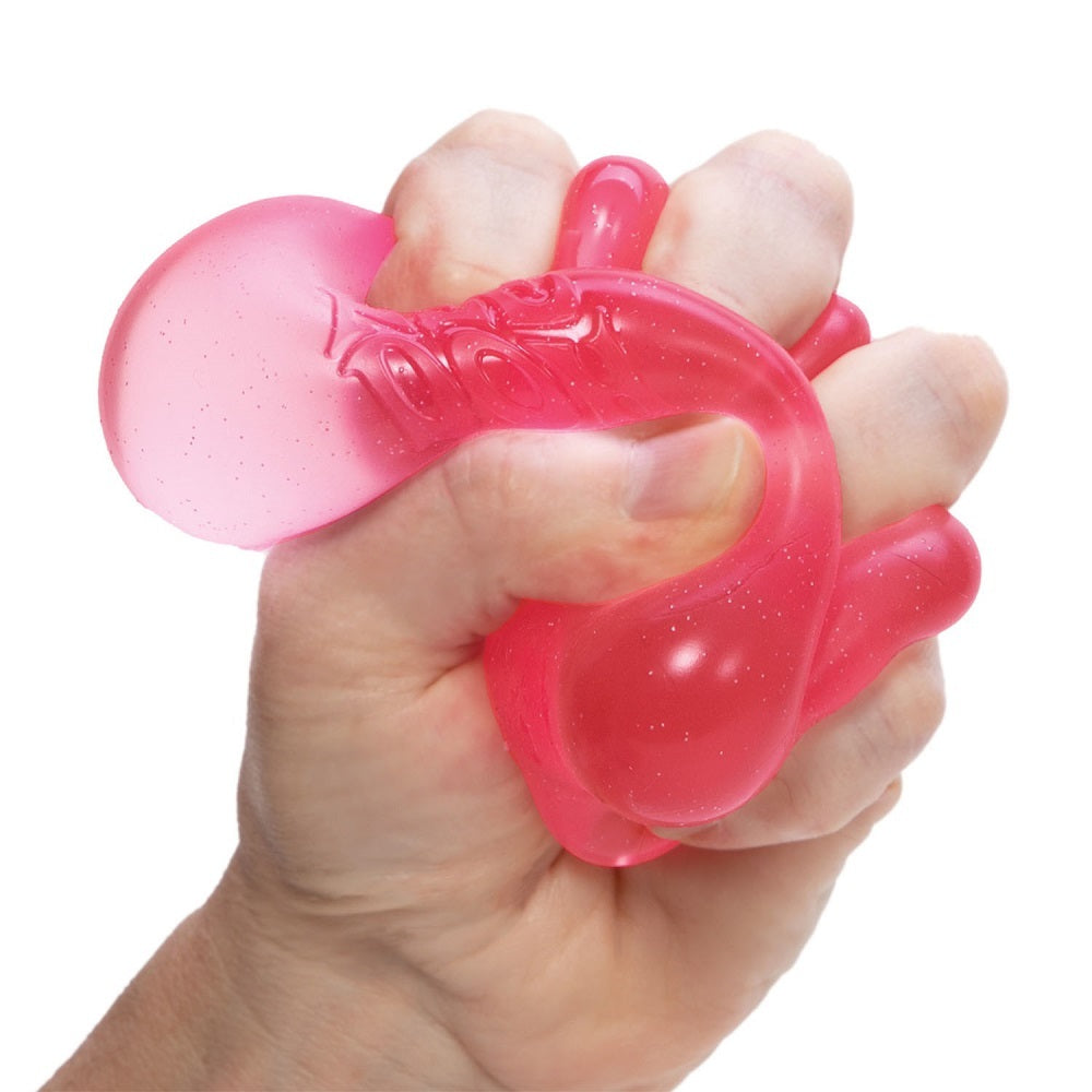 Hand squeezing a pink nee doh nice cube stress