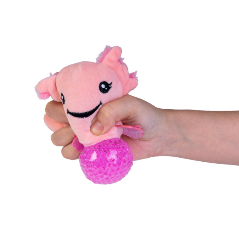 A hand squeezing a pink Axolotl Plush Ball Jelly, showing the satisfying "pop" effect of the internal pink jelly beads through a clear membrane.