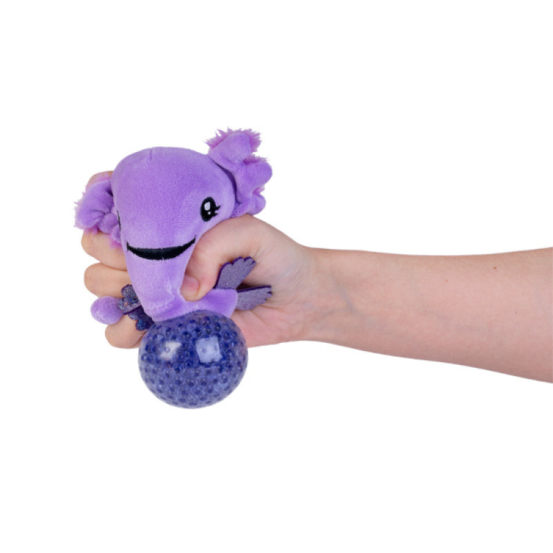 A hand squeezing a purple Axolotl Plush Ball Jelly, showing the satisfying "pop" effect of the internal pink jelly beads through a clear membrane.