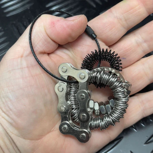 Hand holding a black Kaiko Fidget Loop with metal fidgets attached