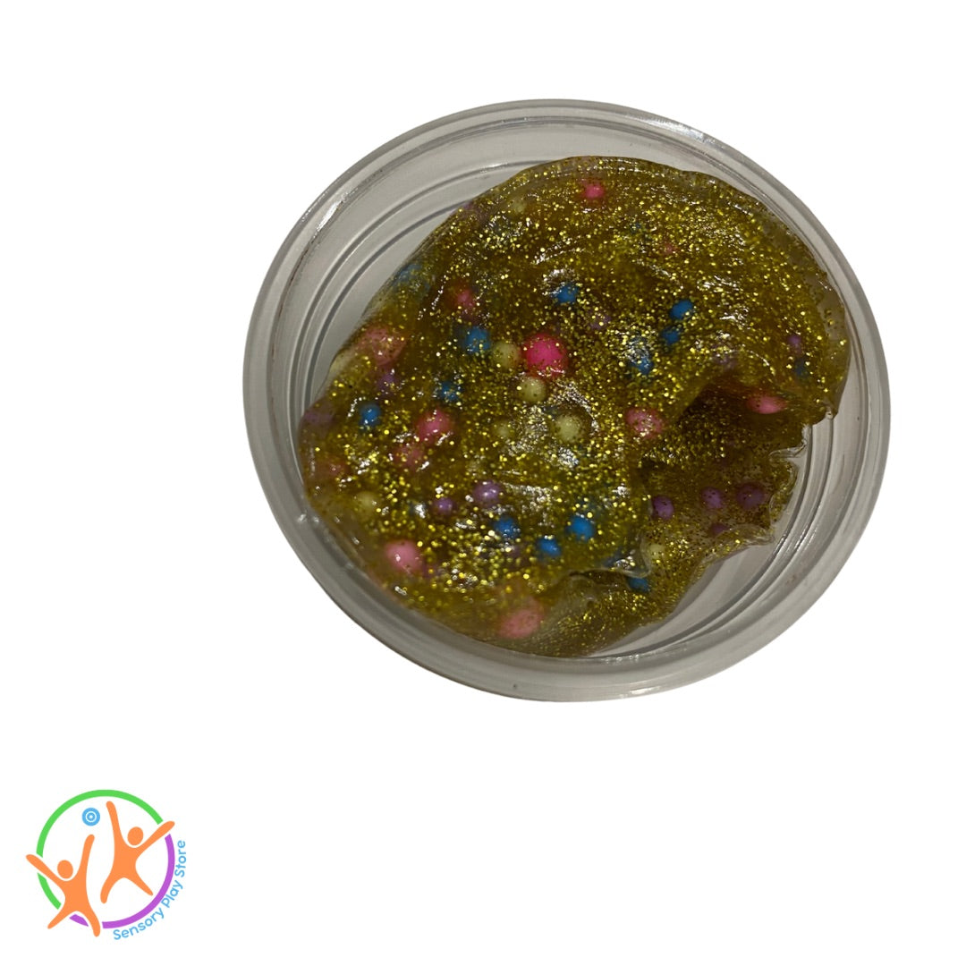 Glittery golden putty with colourful beads to make it crunchy in a clear container