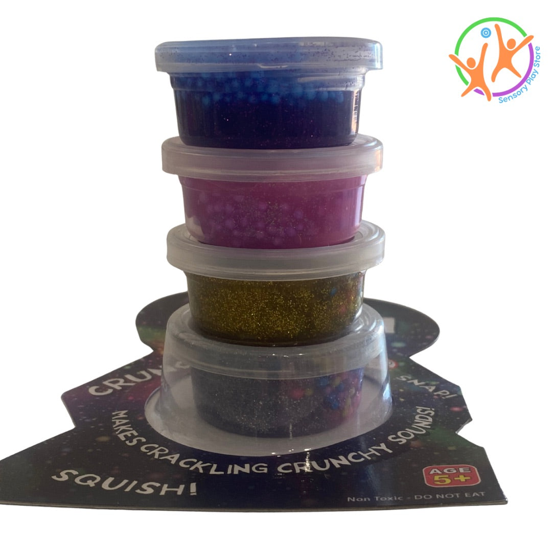 Stack of colourful crunchy putty glitter in small containers with a white background