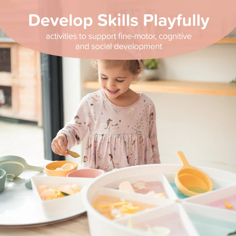 Child playing with sensory play tray and accessories