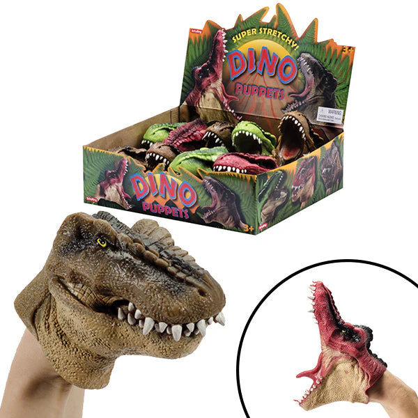 A collection of Super Stretchy Dino Hand Puppets by Schylling, featuring a realistic brown T-Rex puppet on a hand and a red Spinosaurus puppet shown in a wide-mouth stretch. The background shows a colorful retail display box filled with various green, red, and brown dinosaur puppets.