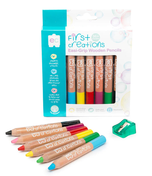 Set of colorful wooden pencils with a sharpener and packaging on a white background