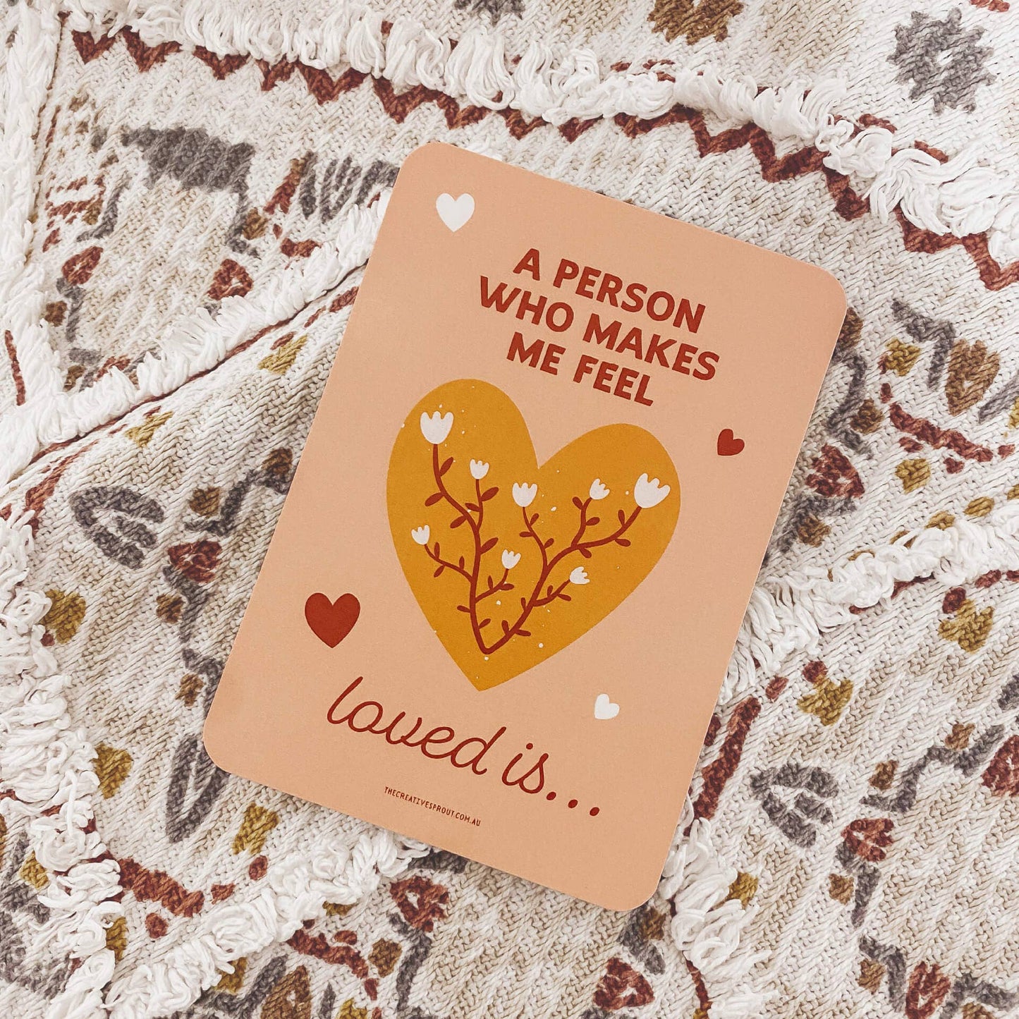 Card with heart design and text on a textured surface