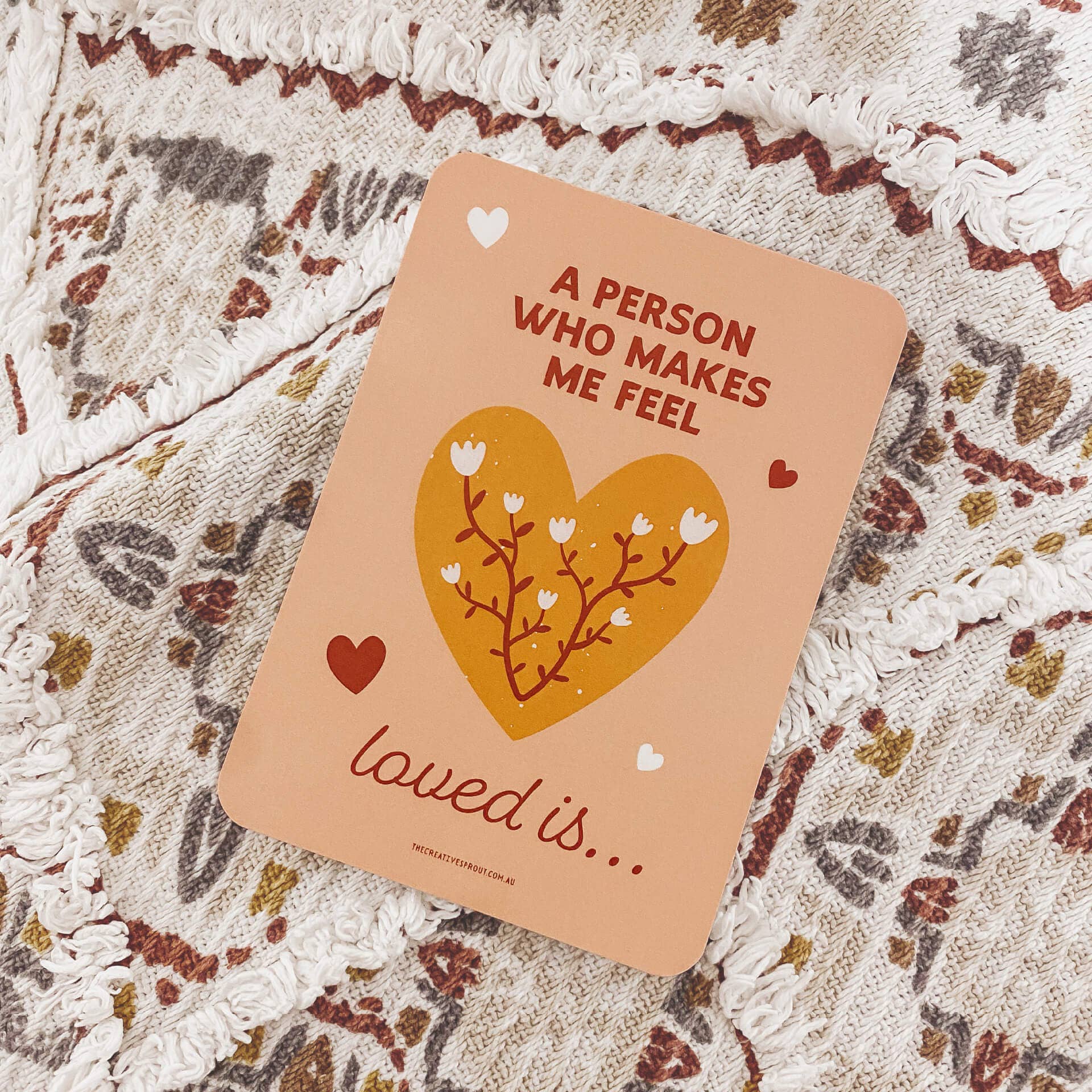Card with heart design and text on a textured surface