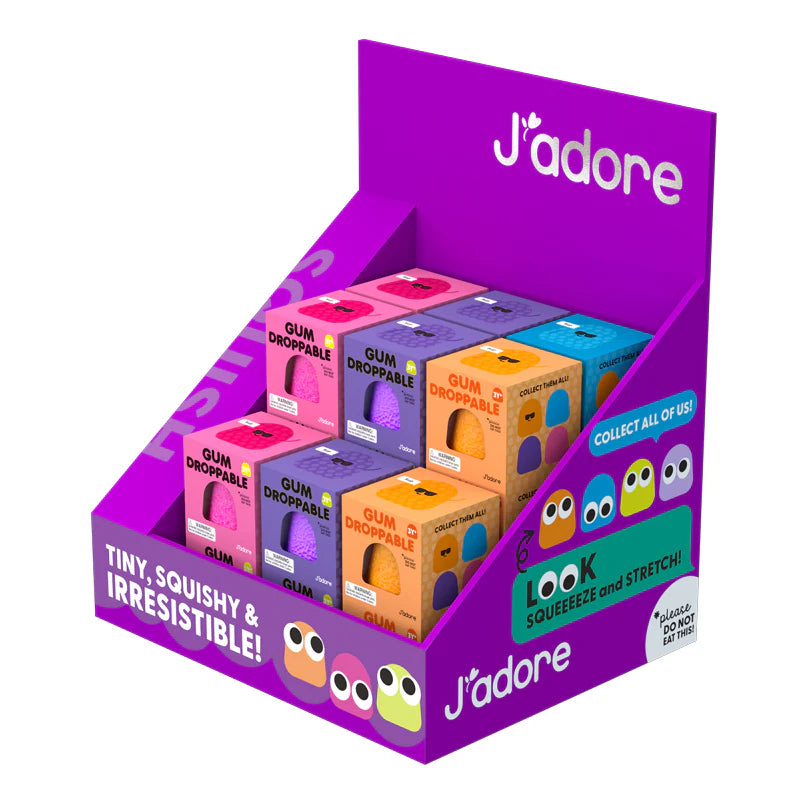 Display box of J'adore gum drops with colourful packaging and branding.
