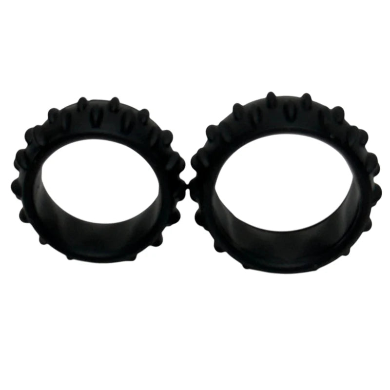 Pair of black silicone rings with textured edges on a white background