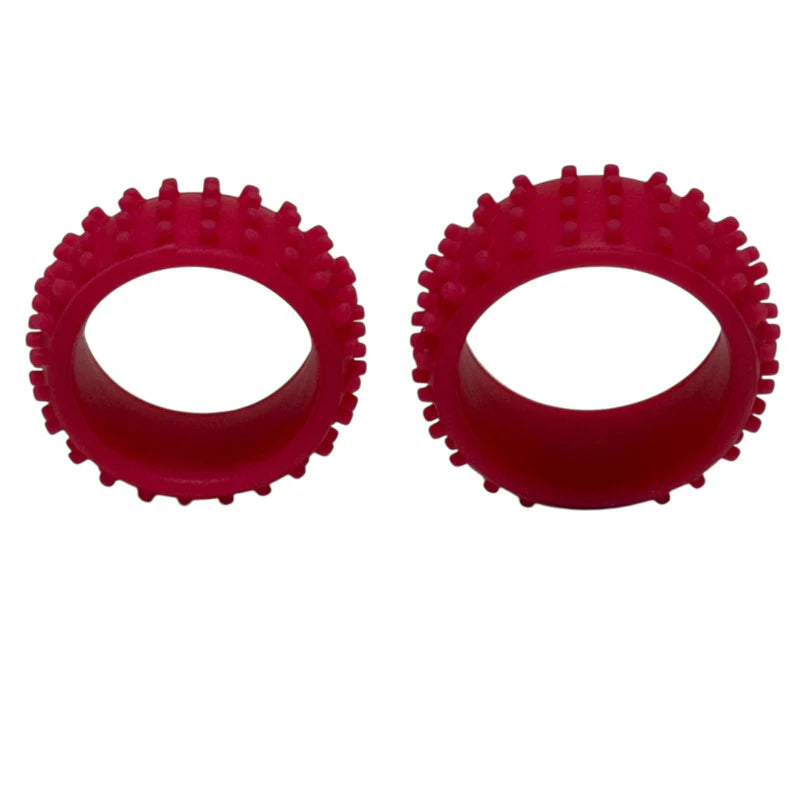 Two red silicone ring toys with textured design on a white background