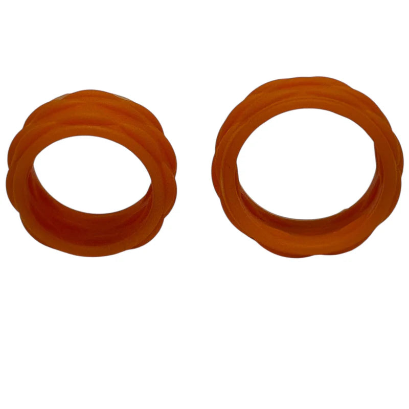 Two orange picky bands rings on a white background