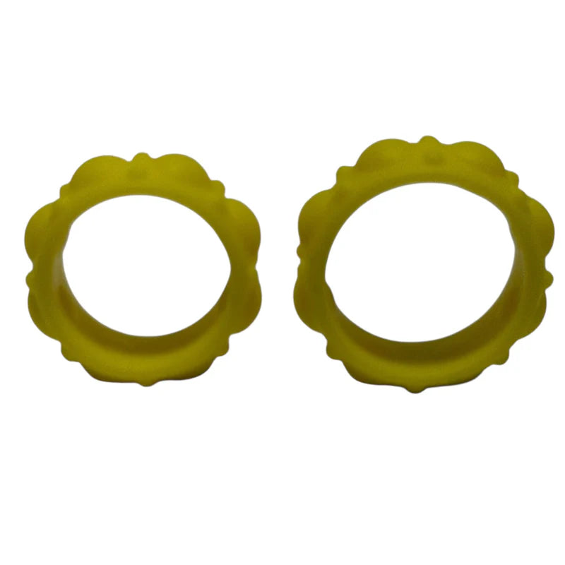 Two yellow silicone rings with scalloped edges on a white background