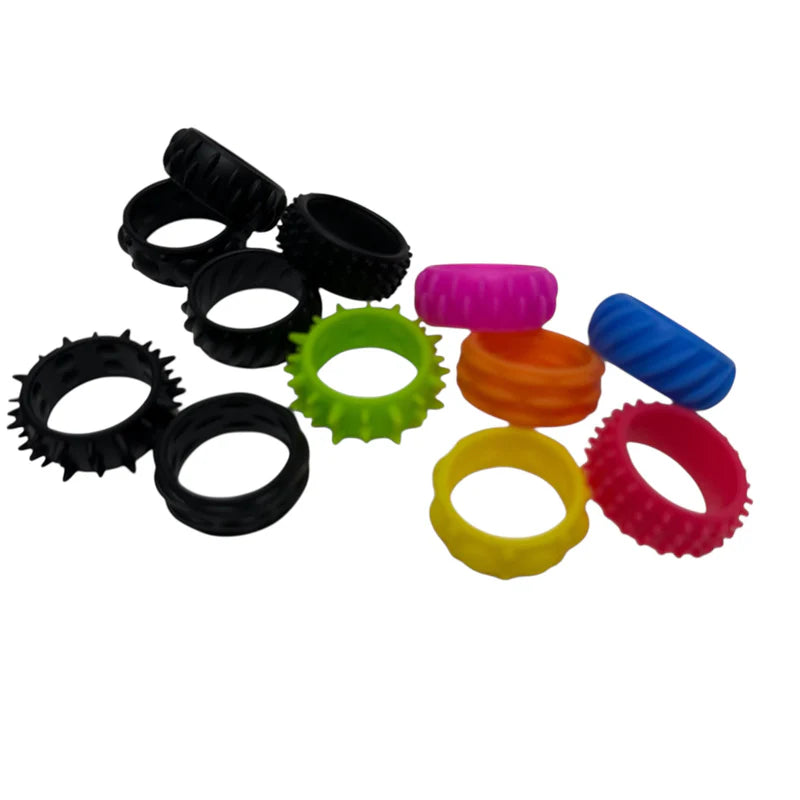 kaiko  Halo Picky Bands silicone rings in black and vibrant colours scattered on a white background