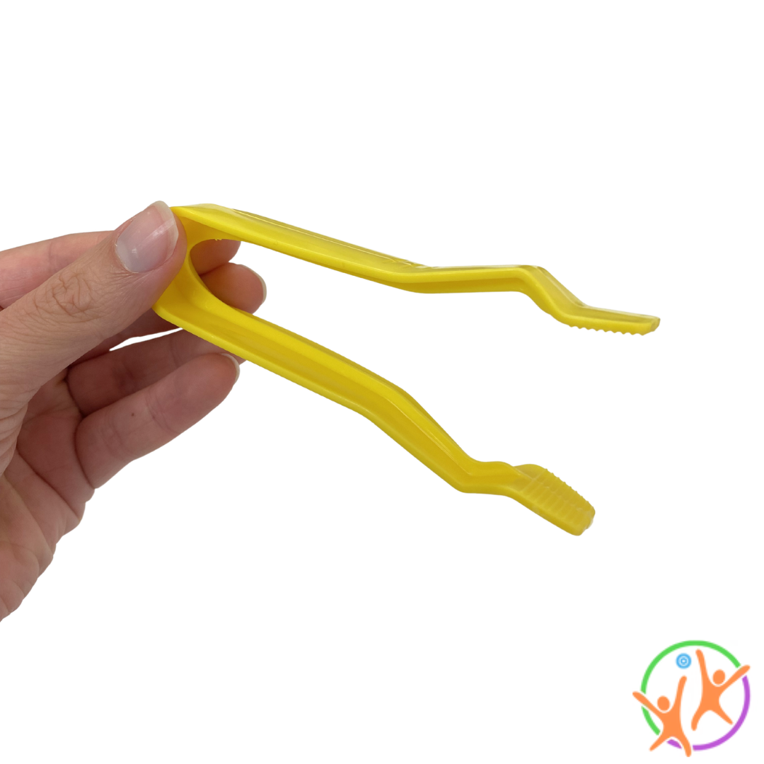 Fingers holding yellow jumbo tweezers