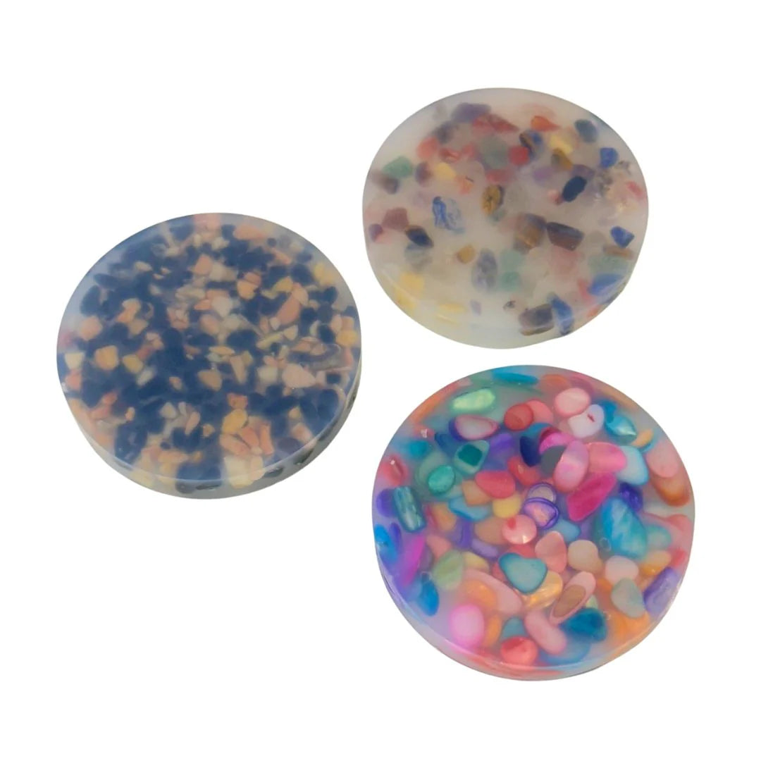 Round silicone Kaiko Mixed Naturals Pick ‘Em Stack picking pad with embedded crystals, shells and stones for satisfying extraction and fidget play.