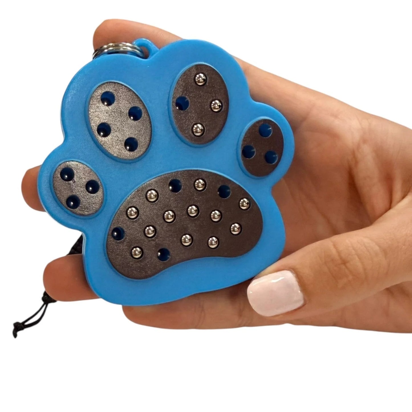 kaiko paw magnetic pad keyring being held by a hand on a white background
