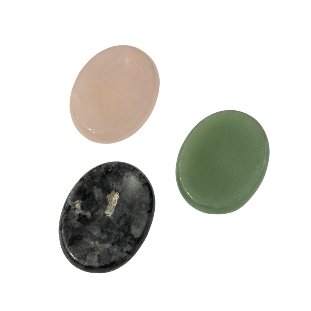 Kaiko rubbing stones showing three natural polished worry stones with thumb indent in rose quartz, green aventurine and black flash for calming sensory fidget use.