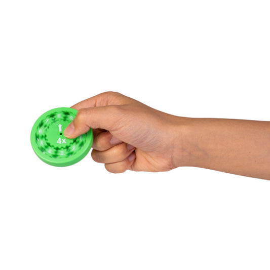 Hand spinning a green Math Fidget Spinner featuring multiplication challenges for interactive learning.
