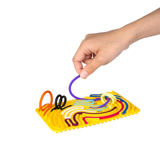 coloured strings being placed on the yellow rectangle Maze Sensory Activity Board