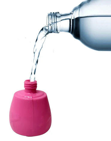 Clear bottle pouring water into a pink base of misting fan